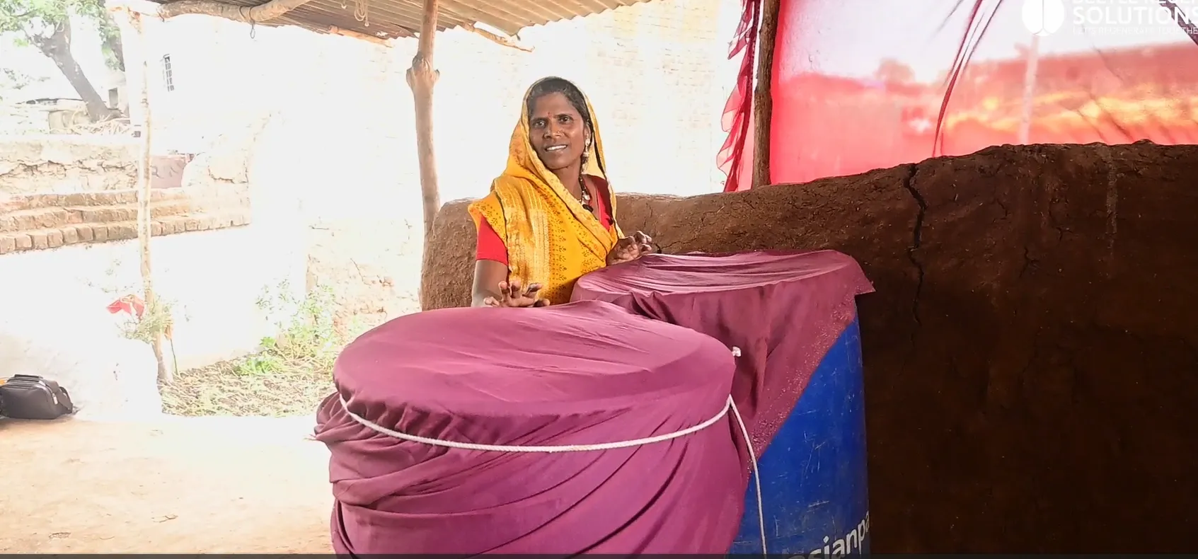 Group of women farmers in a Self-Help Group training session outdoors. Photorealistic photo of a group of eight Indian women farmers sitting together outdoors in a circle during a Self-Help Group training session, one woman demonstrating